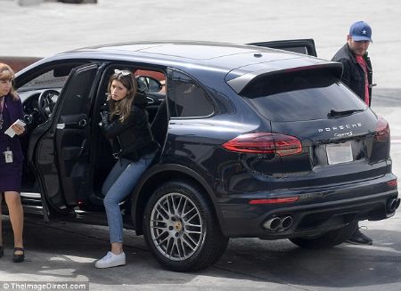 catherine in a casual outfit getting out of her black porsche 